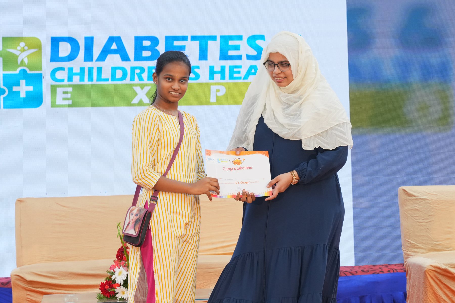 A child receiving a certificate on stage in 2024